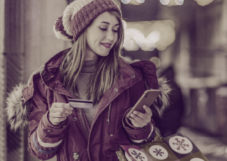 Woman holding credit card and mobile phone
